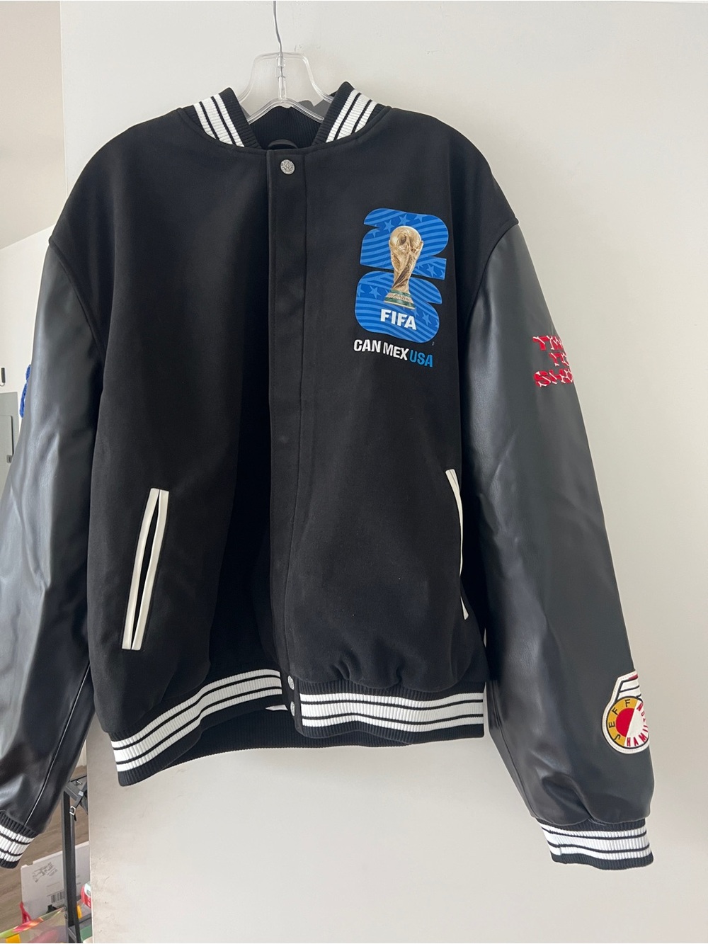 FIFA Jeff Hamilton Black and White varsity Bomber Jacket with Blue Graphic